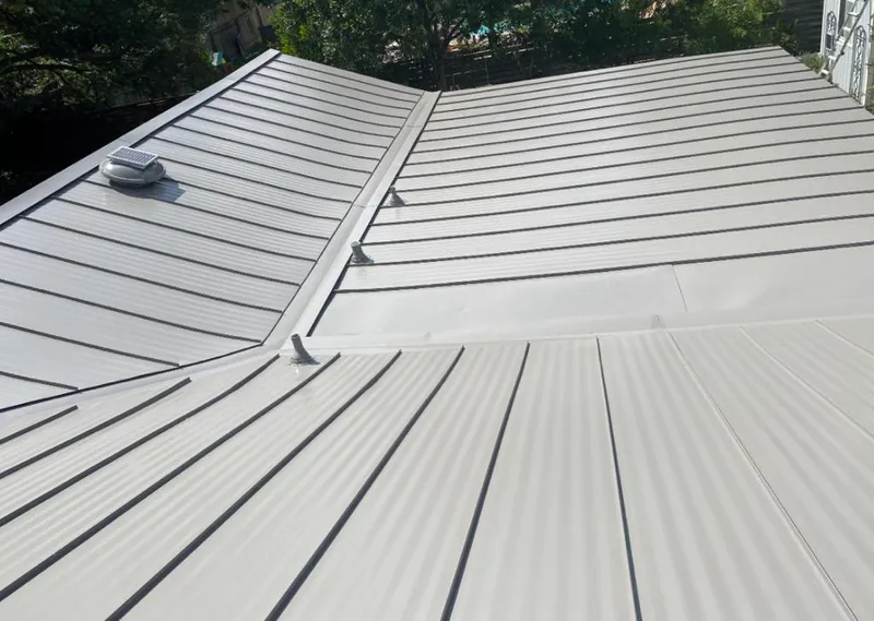 Solar attic fan installed on a metal roof for Roof Ventilation in West Falls Church